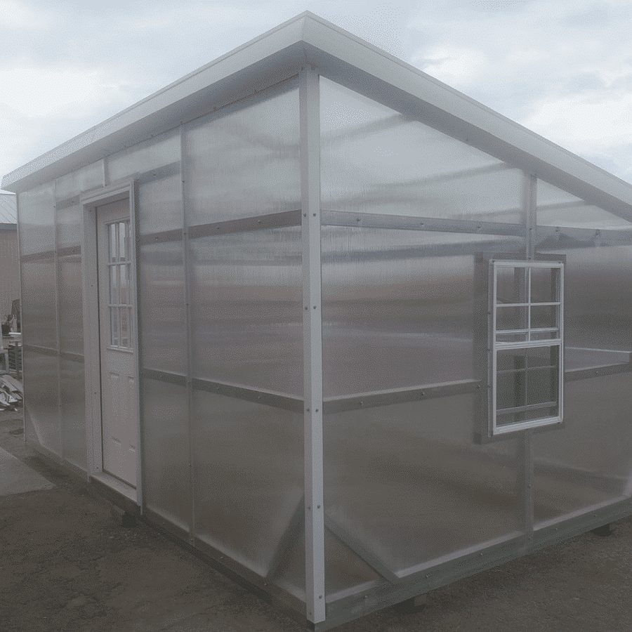 10x16 modern greenhouse in Madras, OR with polycarbonate siding roofing and trim creating clear like appearance and one side window and a white front door