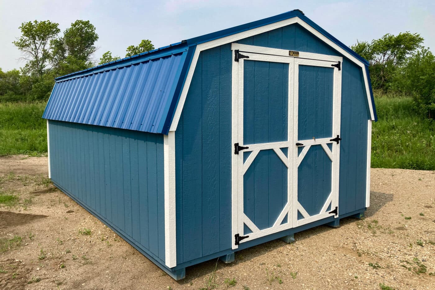 blue lo side shed with white trim and blue metal roofing