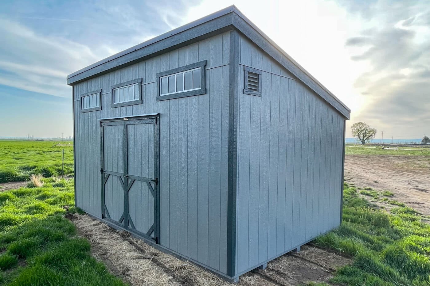 light gray and dark gray trimmed mono slope shed with transom windows