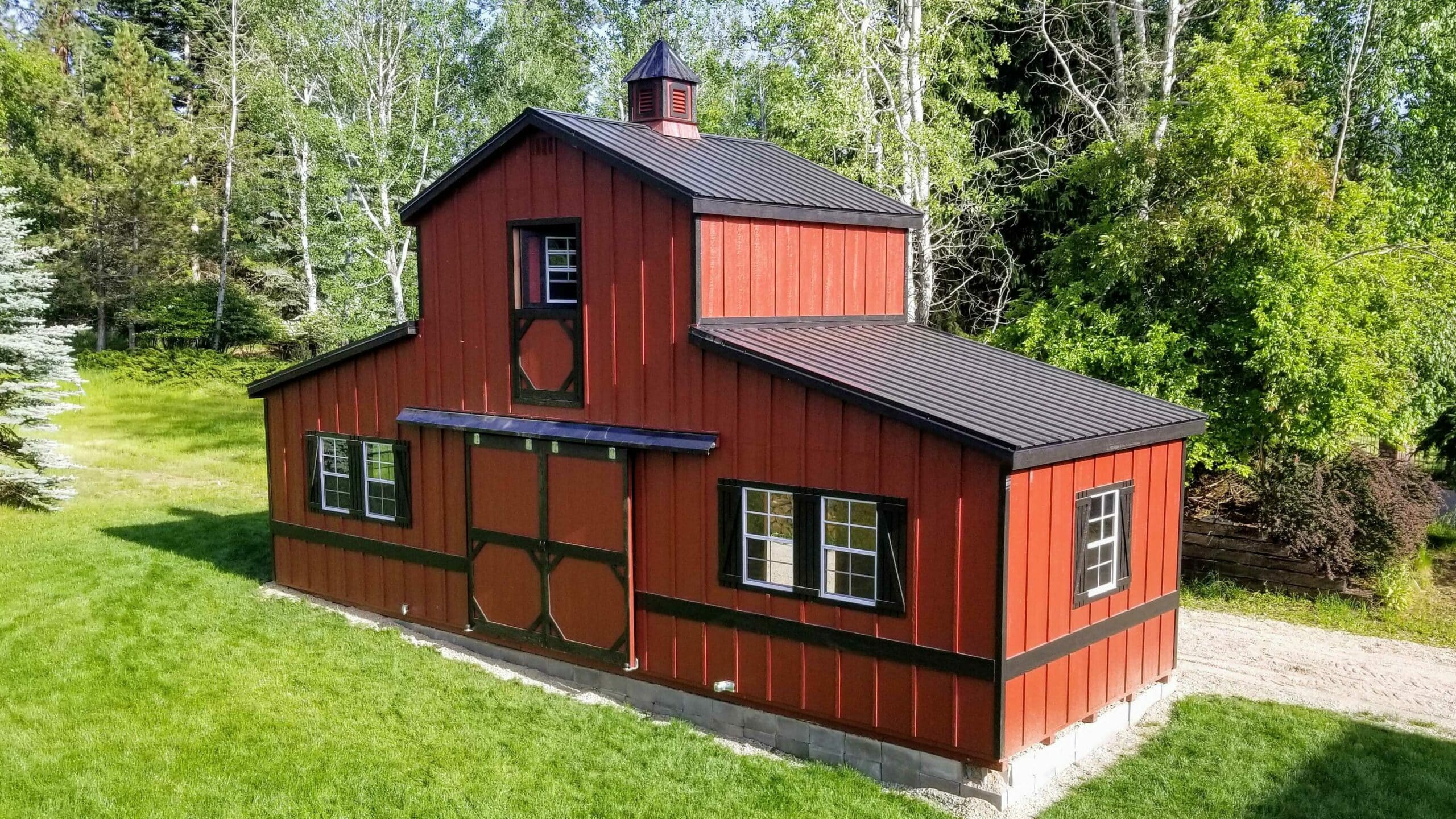 red and black trimmed prestige shed with black metal roof with cupola