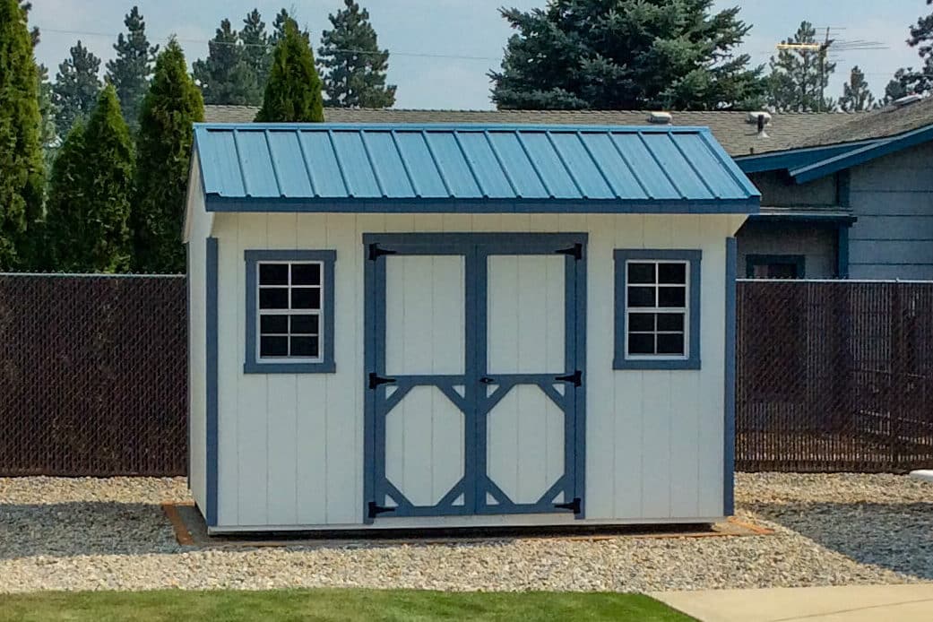 white shed with blue trim and blue metal roofing